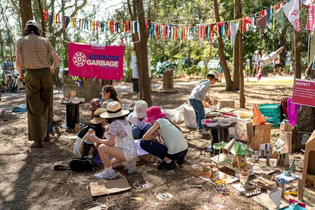 Children creating with recycled materials at a Reverse Garbage activity area