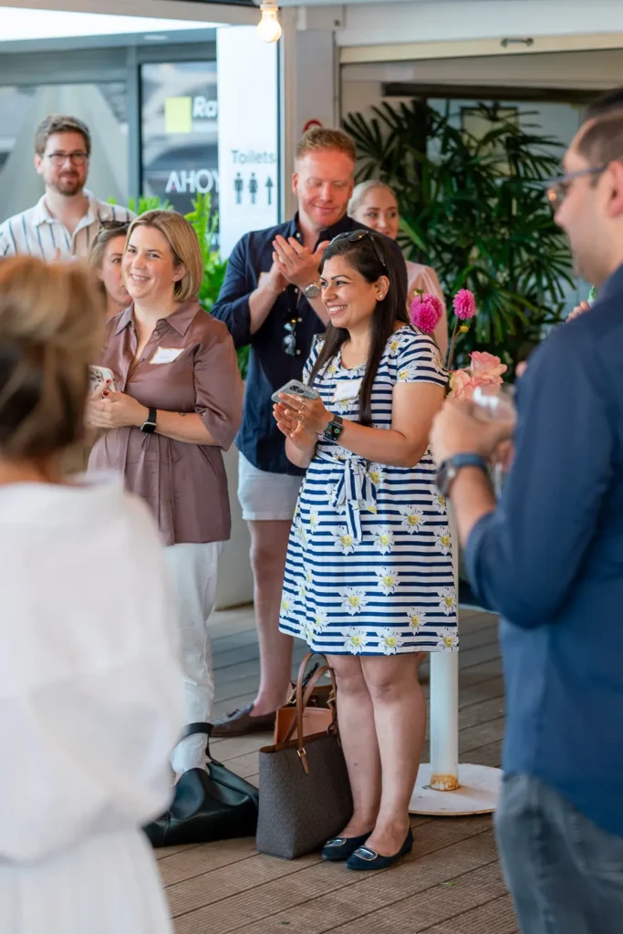 Guests smiling and applauding during the Shift networking event