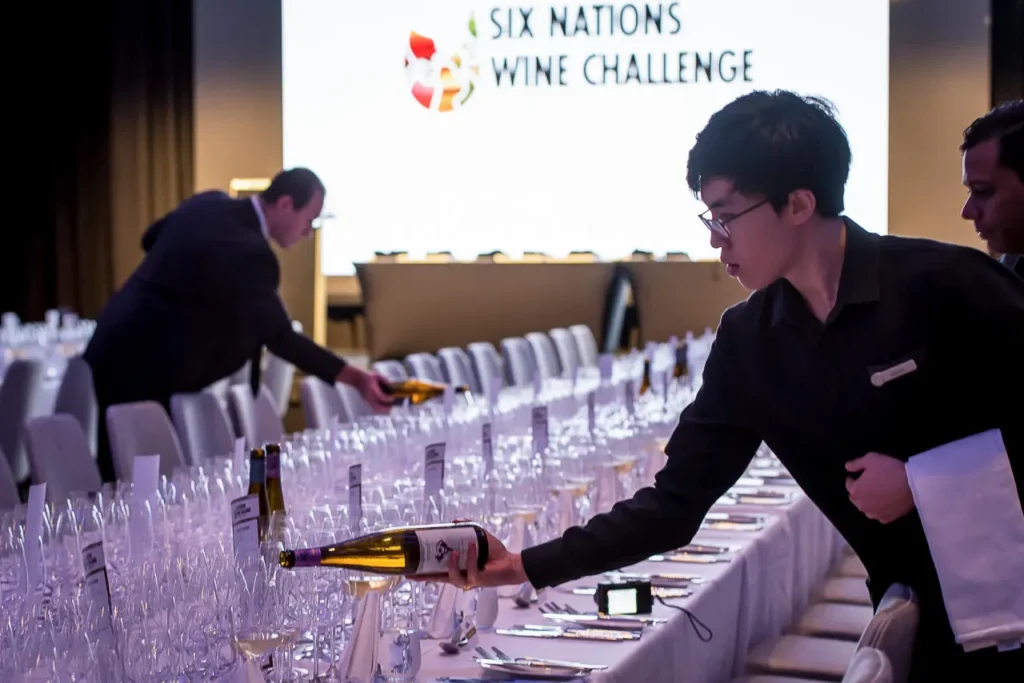 Staff preparing wine glasses for the 2017 Six Nations Wine Challenge dinner in Sydney