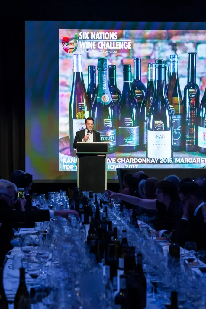 Speaker presenting on stage during the Six Nations Wine Challenge gala dinner
