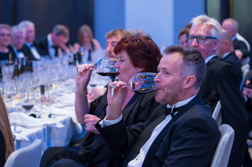 Guests tasting red wine during the Six Nations Wine Challenge dinner