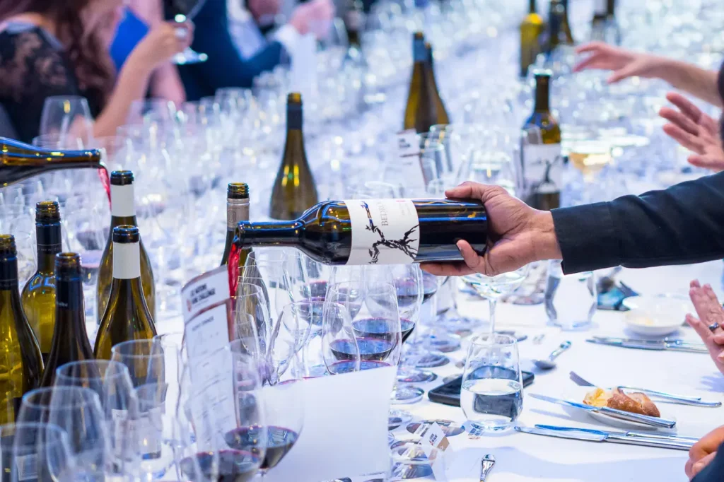 Red wine being poured for guests during the Six Nations Wine Challenge dinner