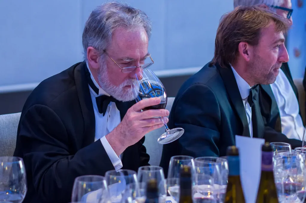 Guest evaluating a glass of red wine at the Six Nations Wine Challenge