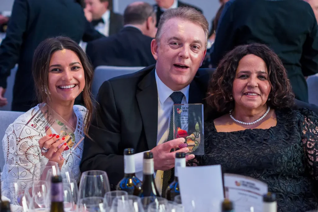 Three guests celebrating with winner awards at the Six Nations Wine Challenge