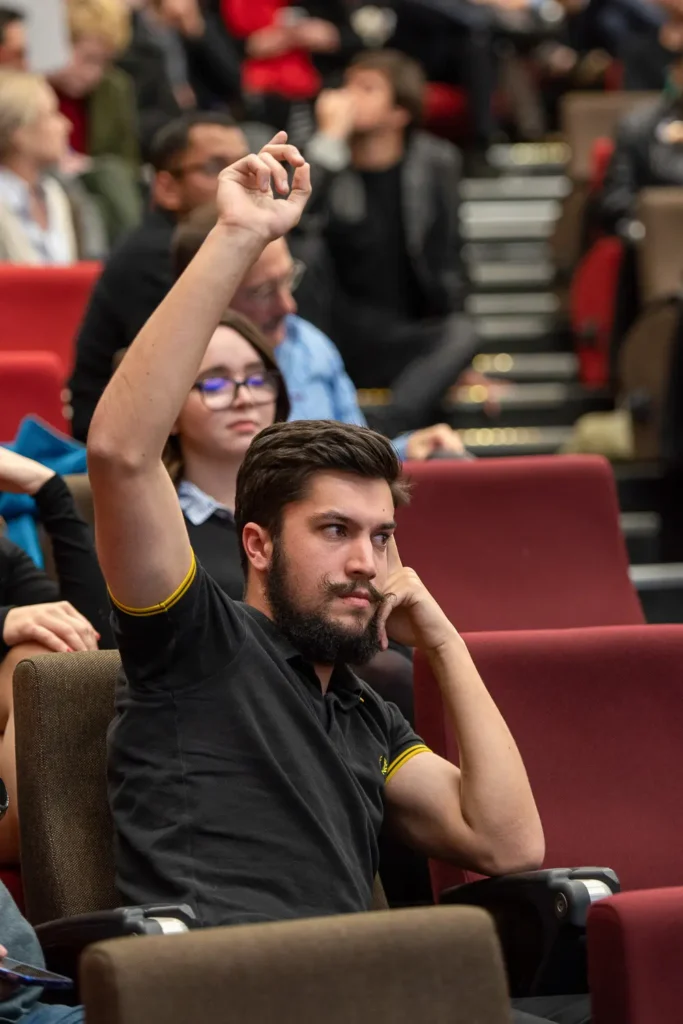 Student raising his hand during a University of Sydney event