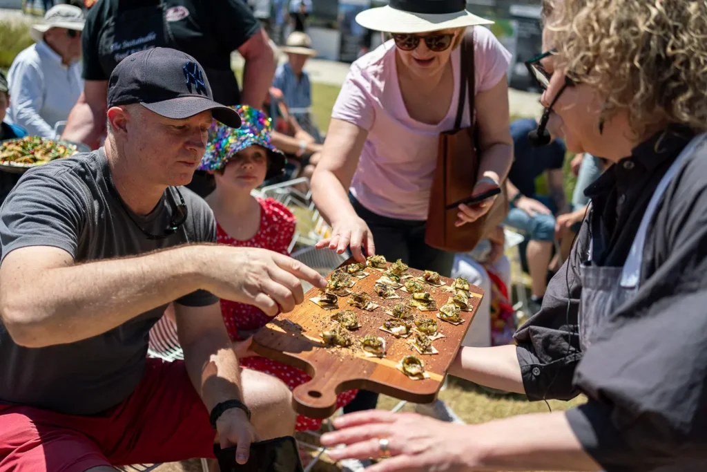 Visitors sampling sustainable food during a cooking demonstration at the Coal Loader festival