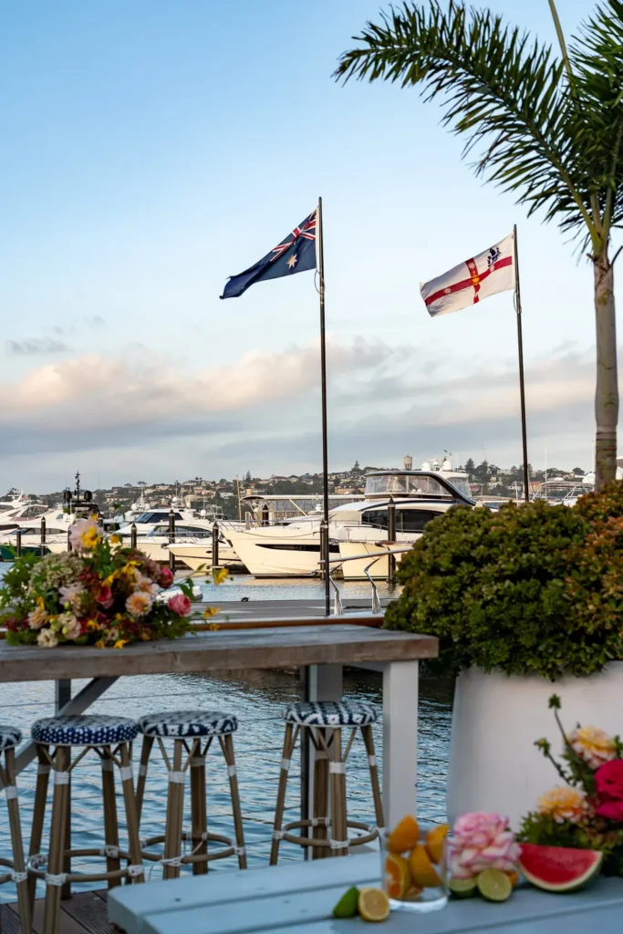 Waterfront event setting overlooking a Sydney marina with flowers and citrus styling