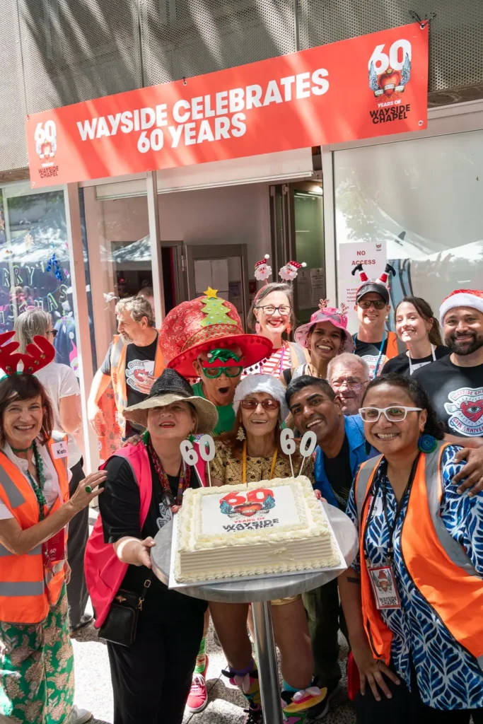 Wayside Chapel community celebrating its 60th anniversary with a Christmas cake in Sydney