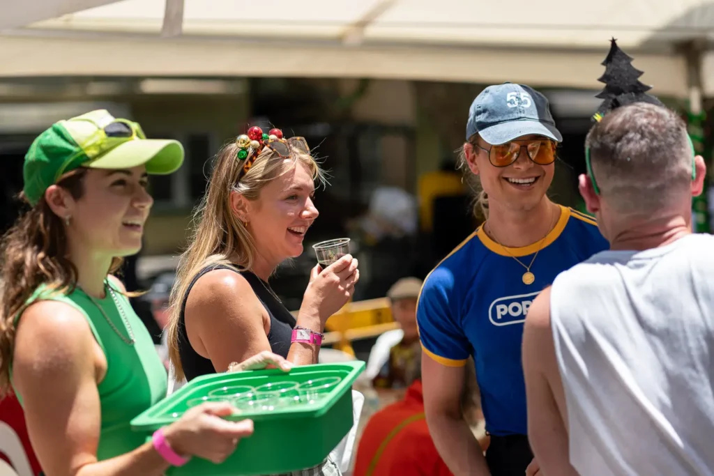 Smiling volunteers enjoying the outdoor Wayside Chapel Christmas celebration