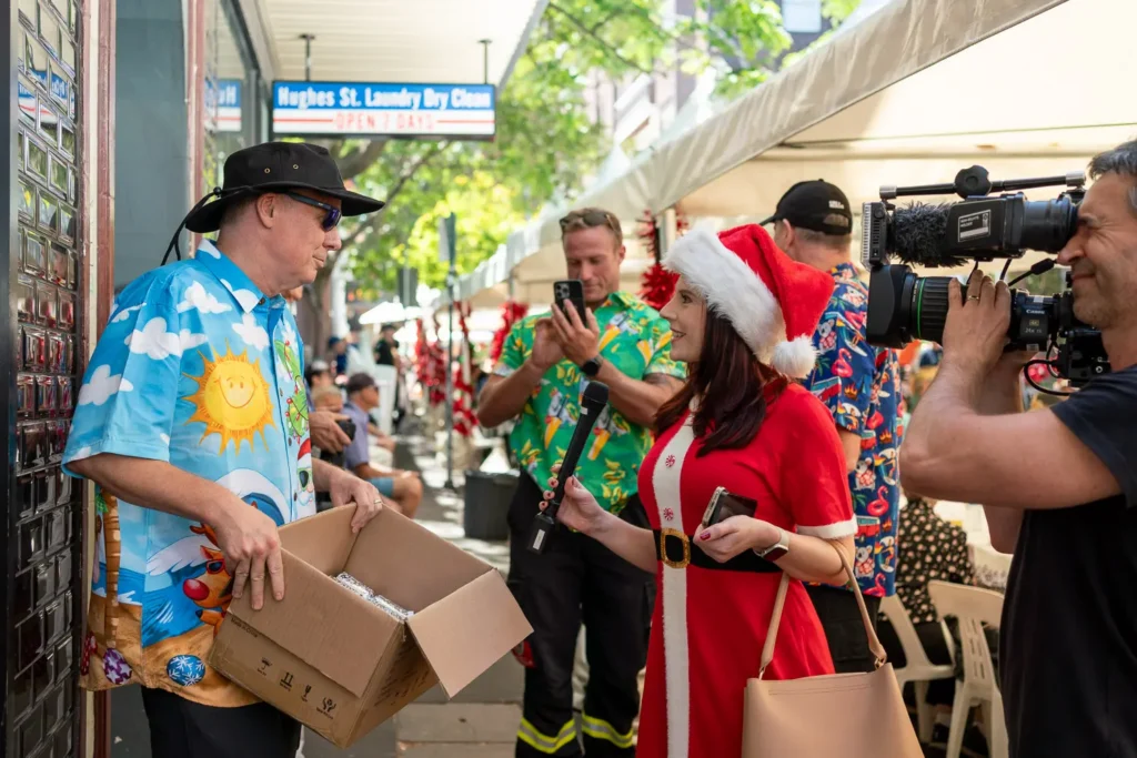 Media interviewing a participant during the Wayside Chapel Christmas Day celebration in Kings Cross