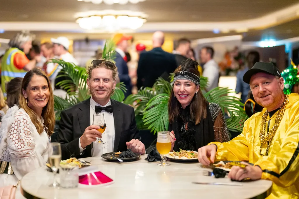 Costumed guests enjoying dinner and drinks at a Sydney corporate party