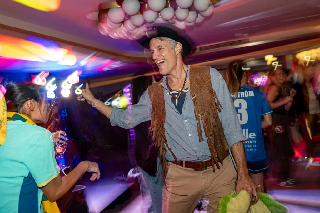 Guest in cowboy costume dancing at a lively Sydney corporate party
