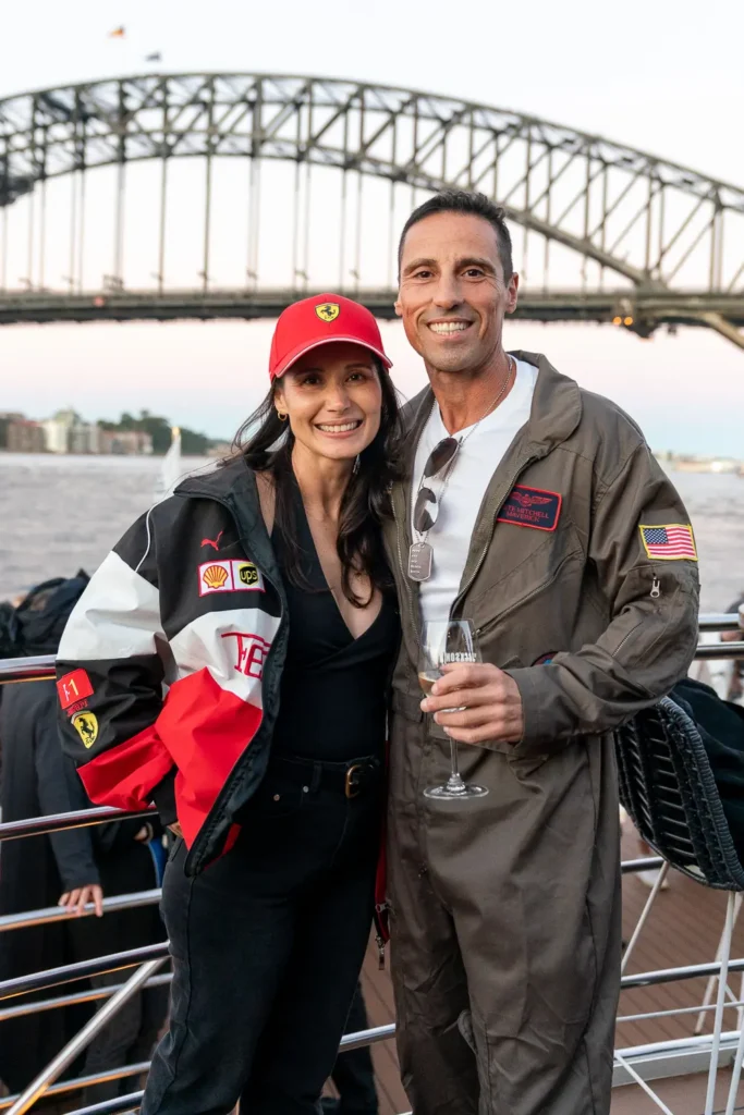 Costumed guests posing at a corporate event with Sydney Harbour Bridge behind them