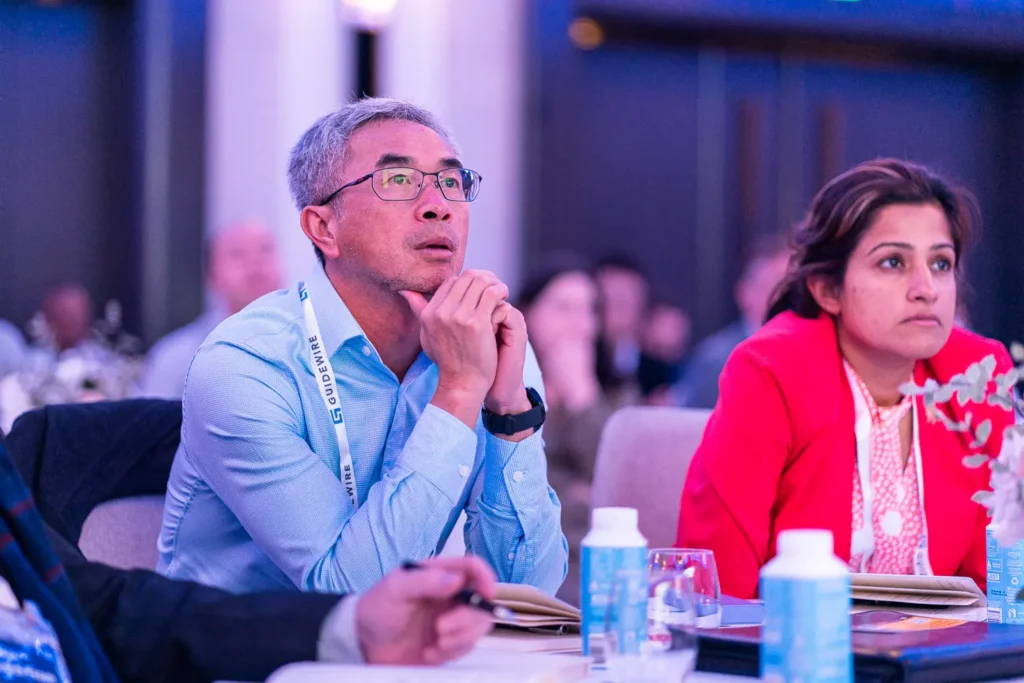 Conference attendees watching a presentation at Four Seasons Hotel Sydney