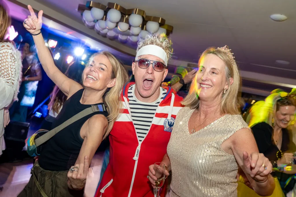 Costumed guests dancing together at a lively Sydney corporate party
