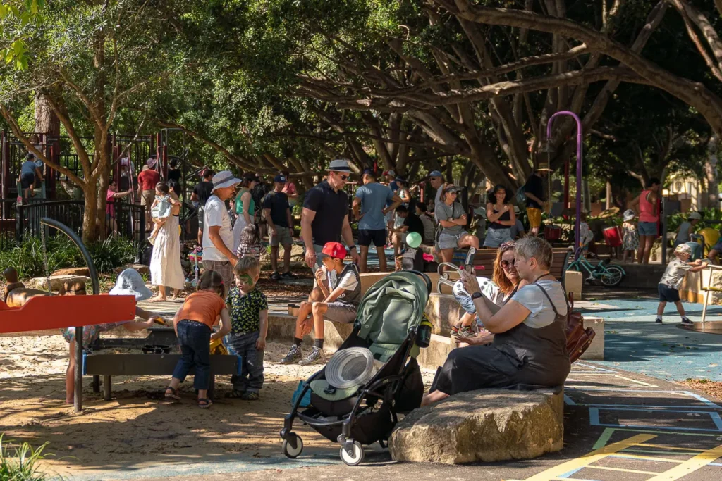 Event photography capturing families enjoying a bubble performance at the St Leonards Park opening