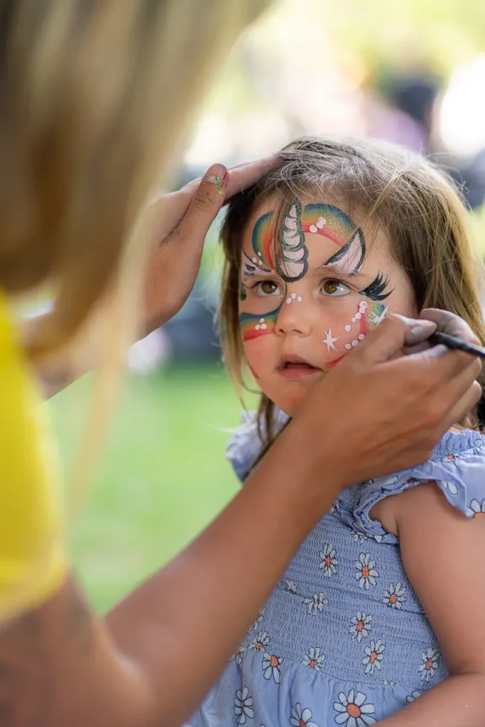 Event photography capturing face painting at the St Leonards Park community opening in North Sydney