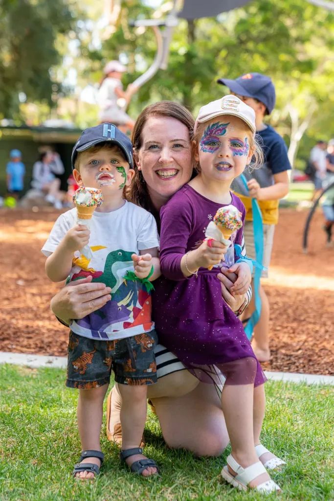 Family event photography capturing a parent and children enjoying the St Leonards Park playground opening