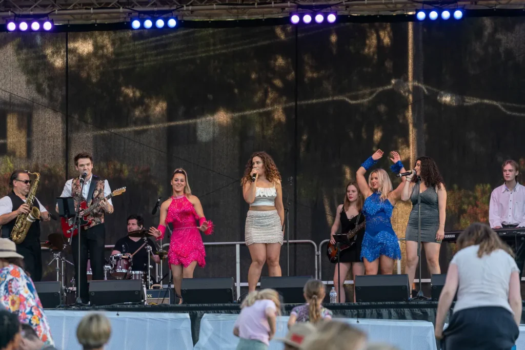Live band with singers, dancers and musicians performing at North Sydney Sunset Series 2022