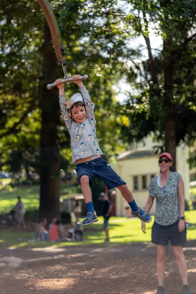 Event photography of a child enjoying the flying fox at the St Leonards Park playground opening