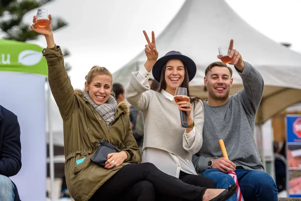 Friends enjoying drinks and the festival atmosphere at Taste of Manly