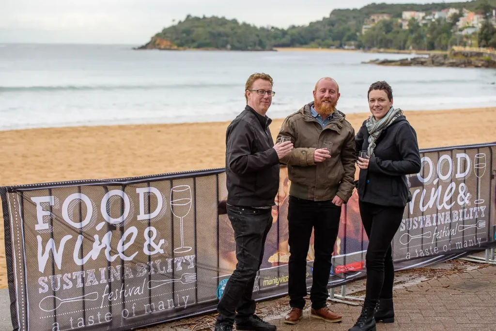 Festival visitors enjoying wine beside Manly Beach