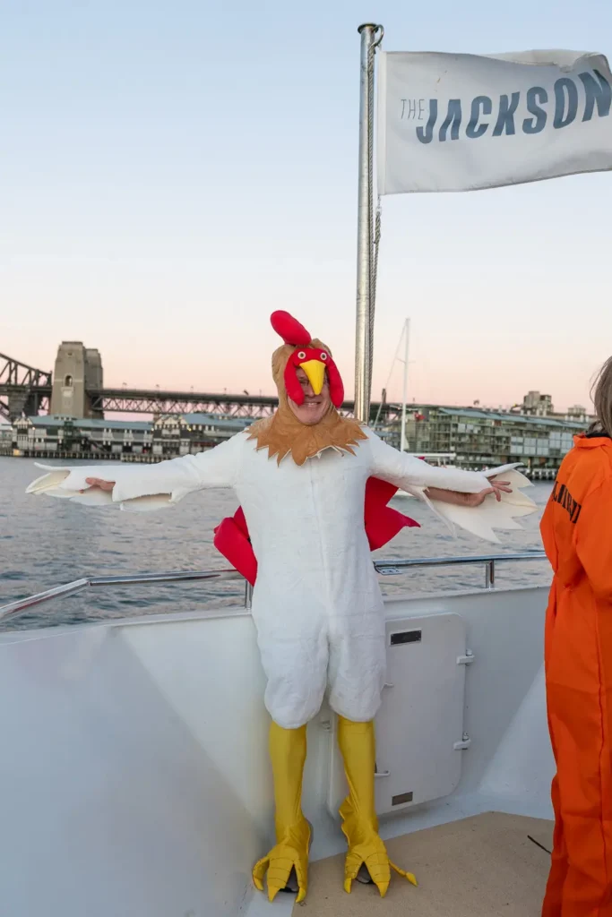 Costume party guest aboard The Jackson with Sydney Harbour Bridge in the background